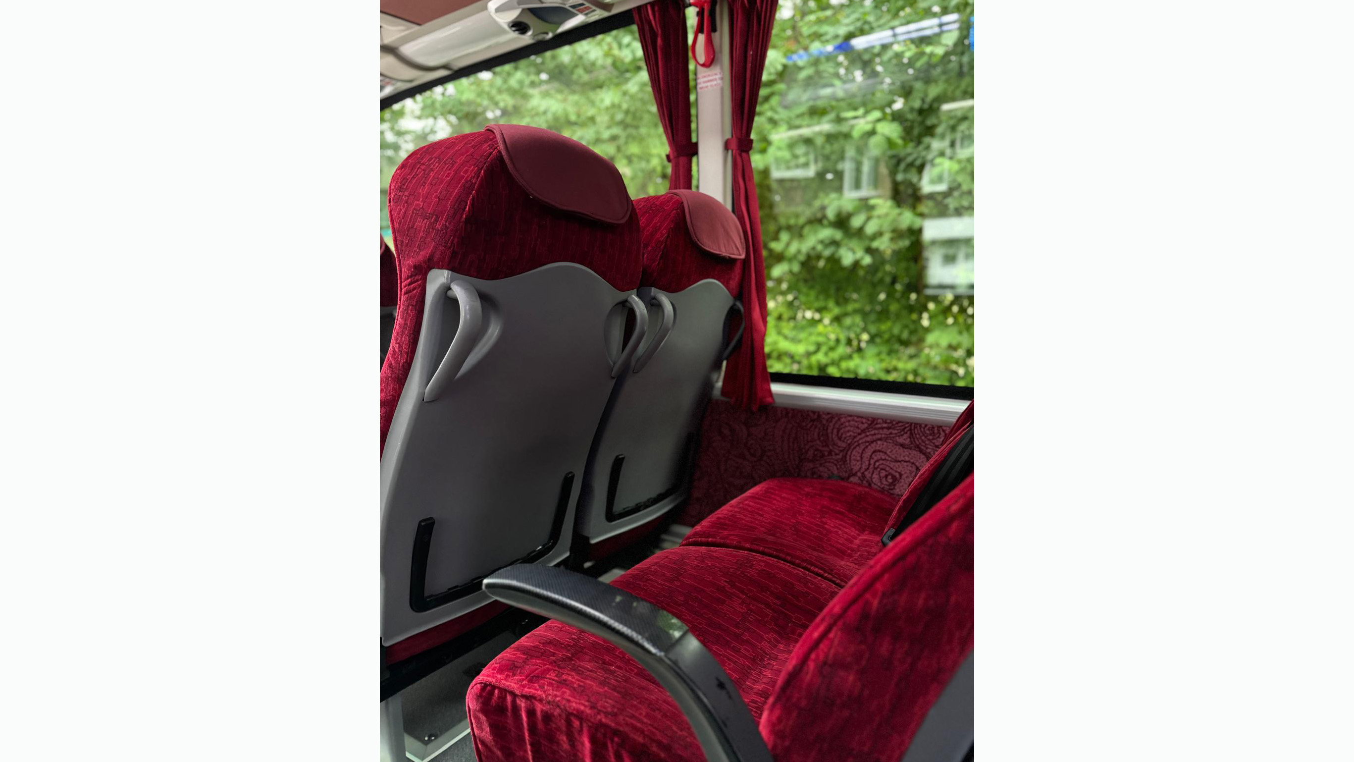 Burgundy seats insode a modern coach