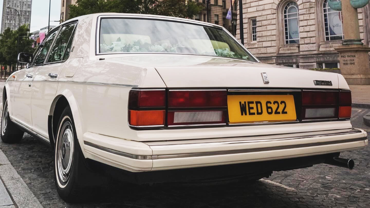 Rear view of a classic White Rolls-Royce silver spirit