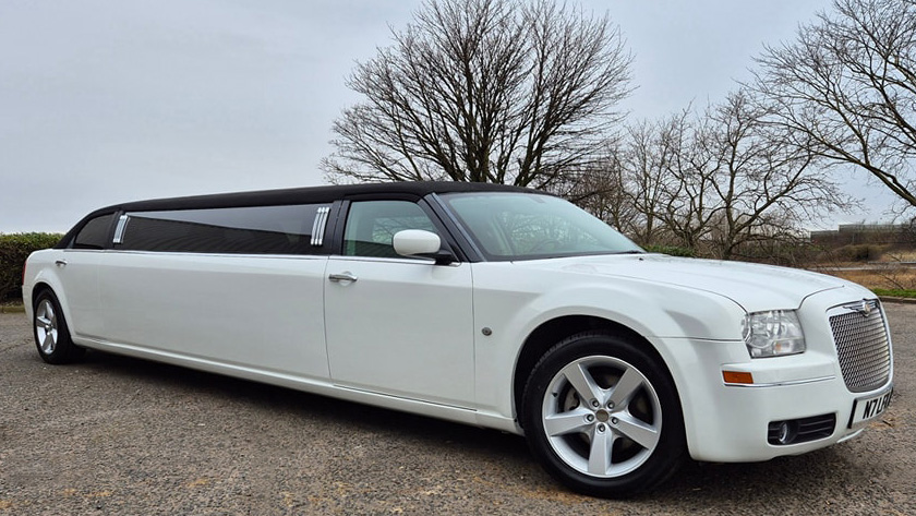 White Stretched Limousine with a black roof and tinted windows