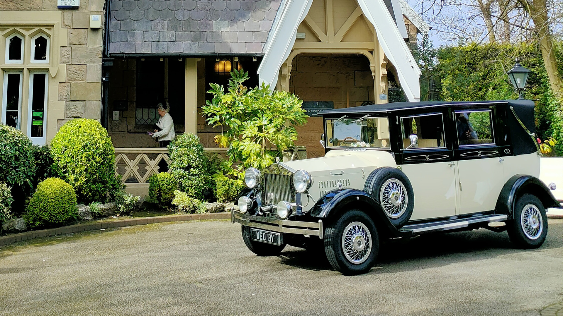 Black and Ivory vintage imperial car with spare wheel mounted on the side of the vehicle