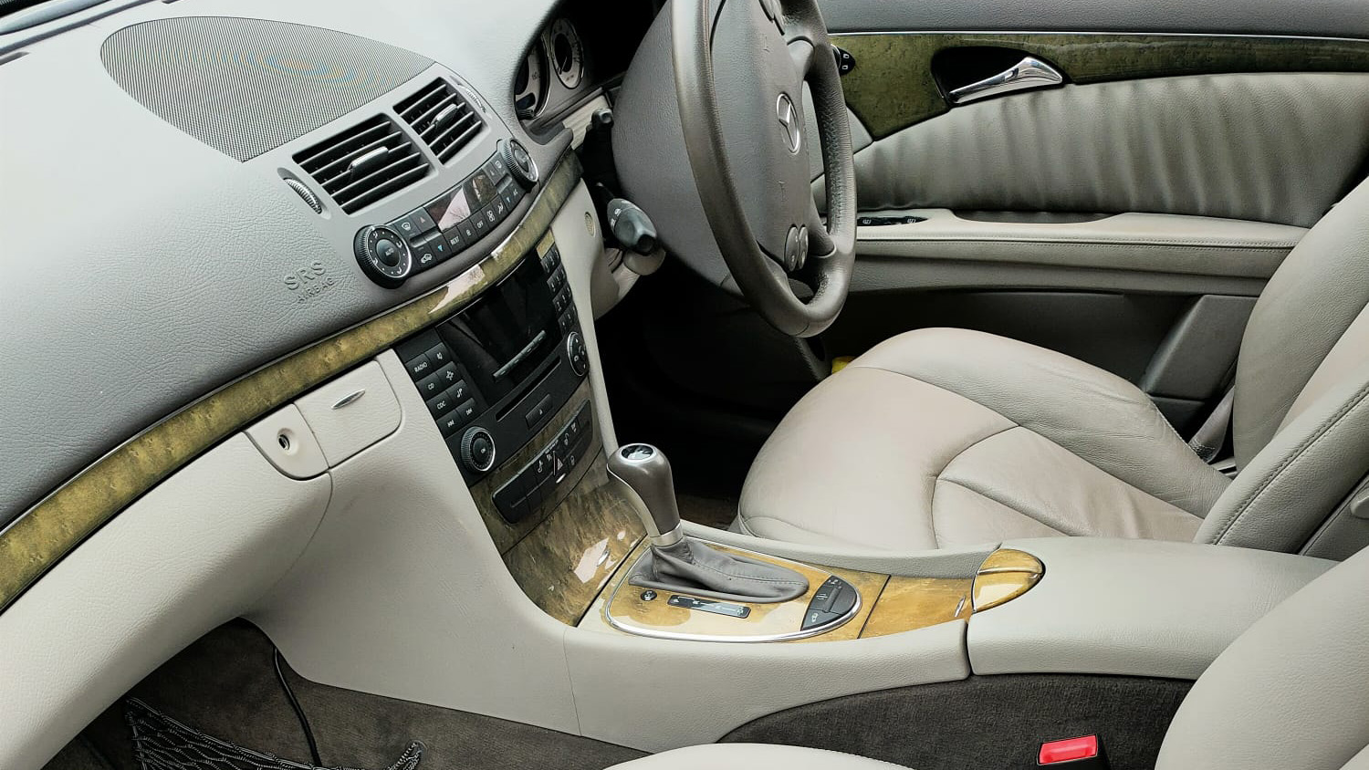 Front driver seat and dashboard inside Mercedes E-class limousine