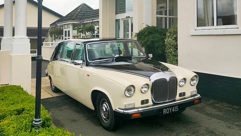 Front view of classic Daimler limo in Ivory with black roof and bonnet