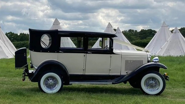 Right side view of a vintage Badsworth with black soft top roof close