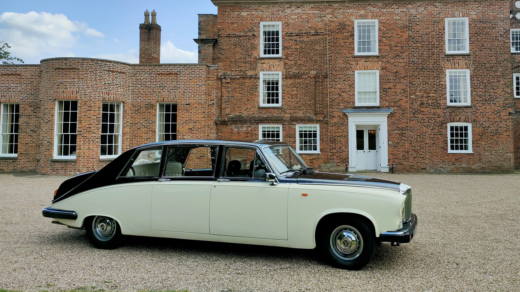 Right side view of a classic limousine in Black and Ivory