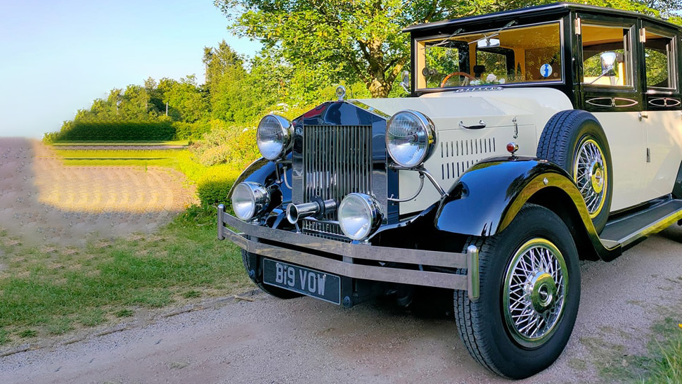 Vintage car with chrome spoke wheel and spare wheel mounted on the side of the vehicle