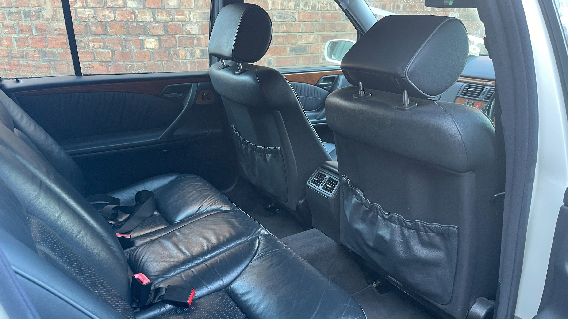 Black leather interior seats inside stretched Mercedes Limousine