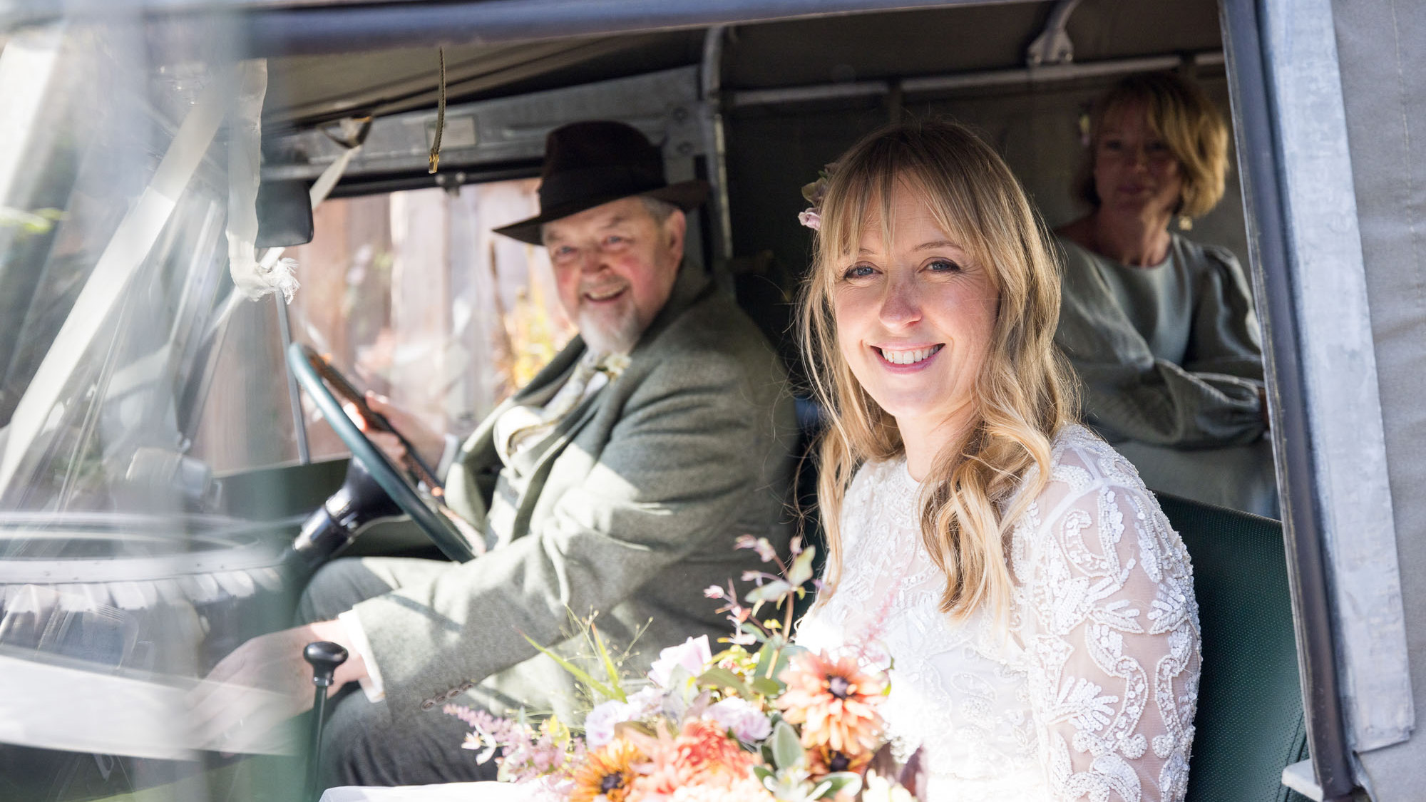 Bride and Groom seating inside a Classic Land Rover