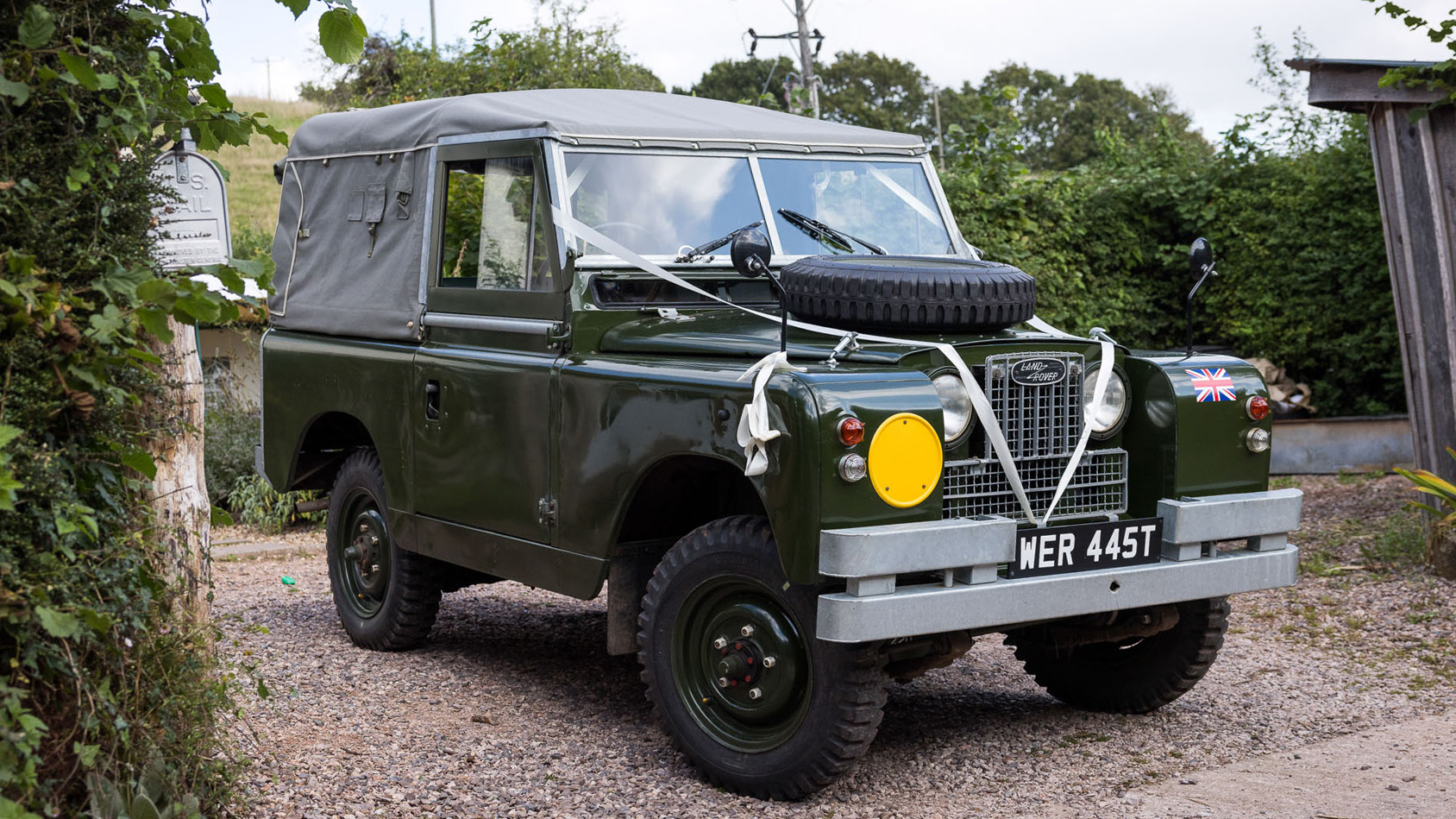 Classic Landrover Series 2 in Army Green with Light grey Canvas decorated with white wedding ribbons