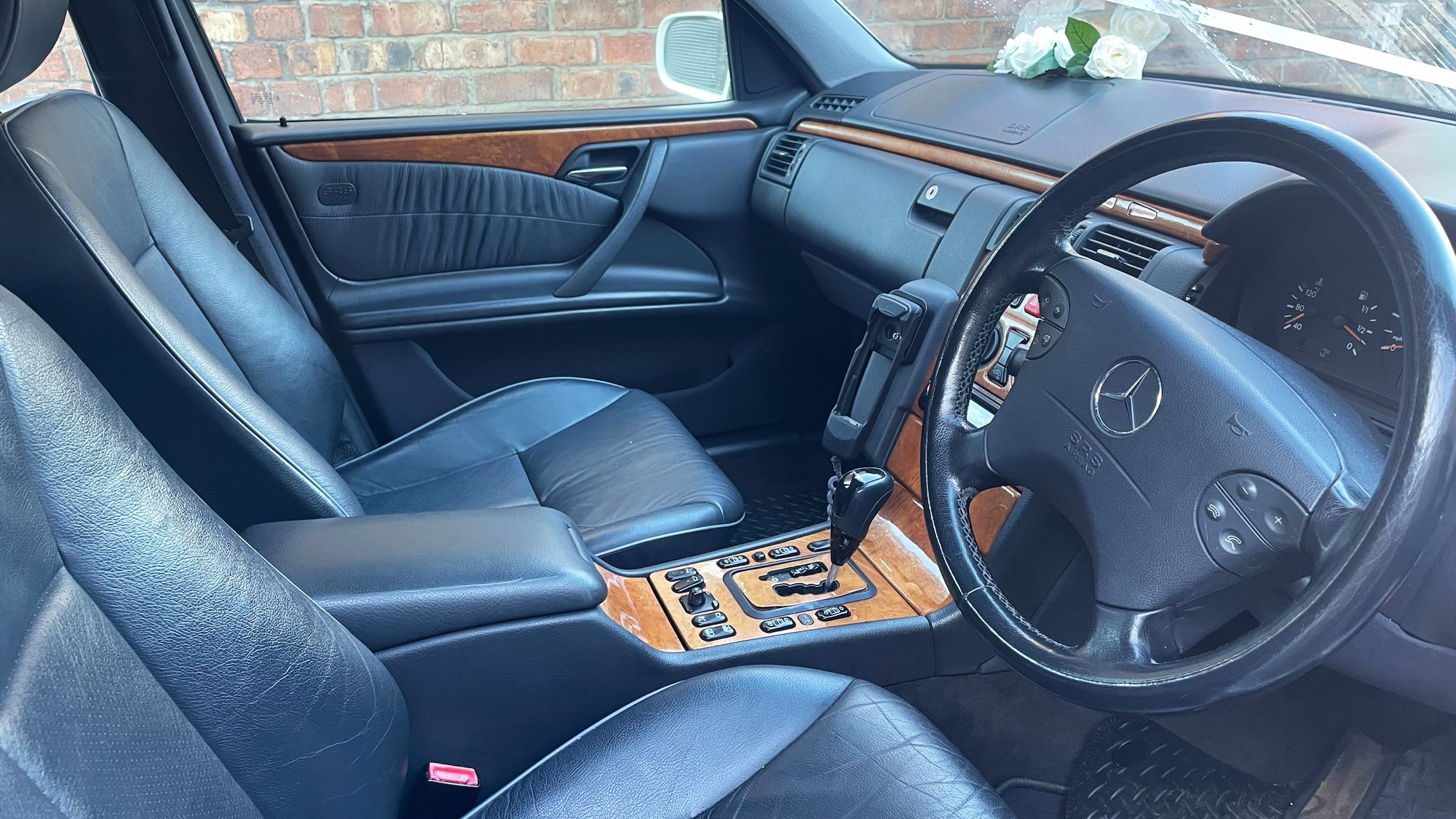 Font passenger seat inside stretched Mercedes with wooden feature on dashboard