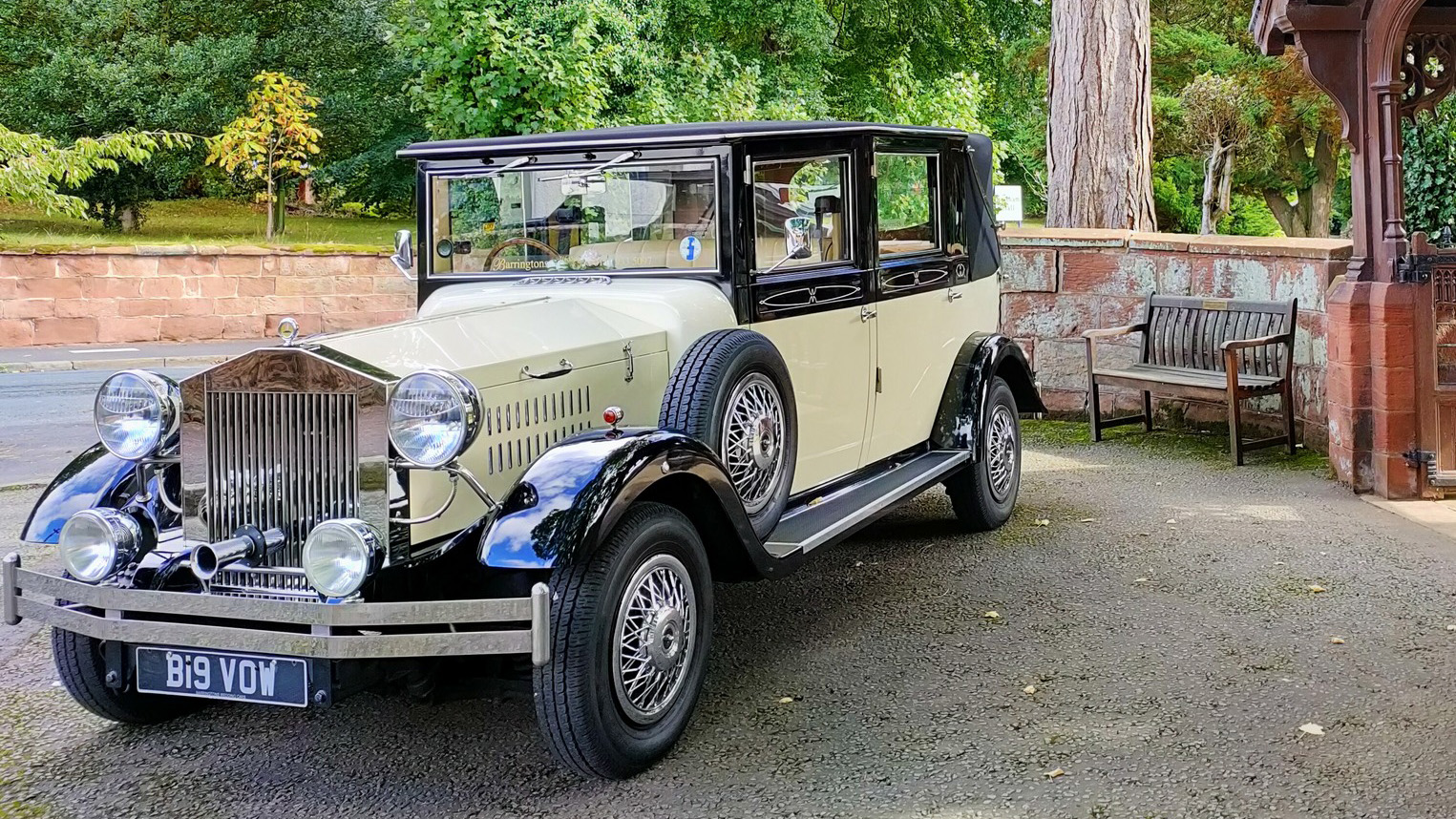 Black & Ivory vintage Imperial wedding car parked in front of a wedding Church