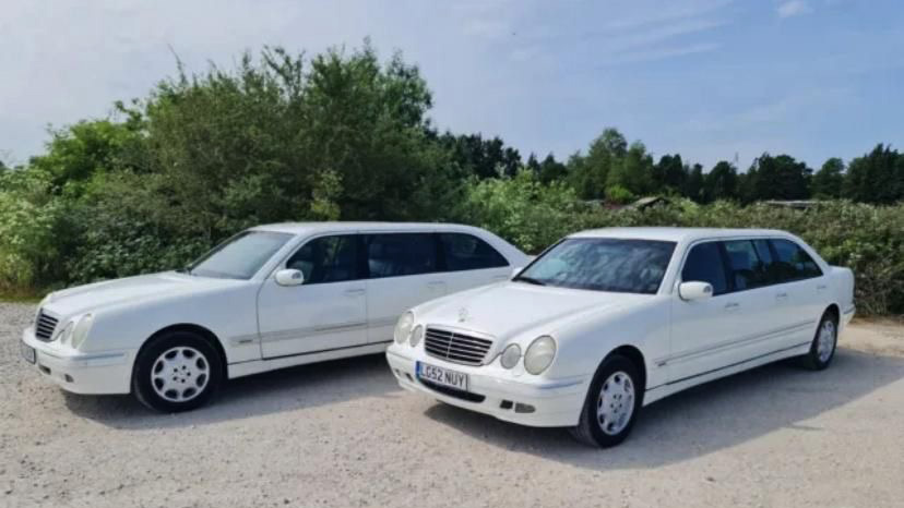 two identical white Mercedes stretched limousine