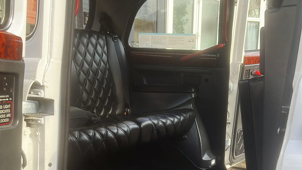 Rear seat black leather interior inside Taxi Cab