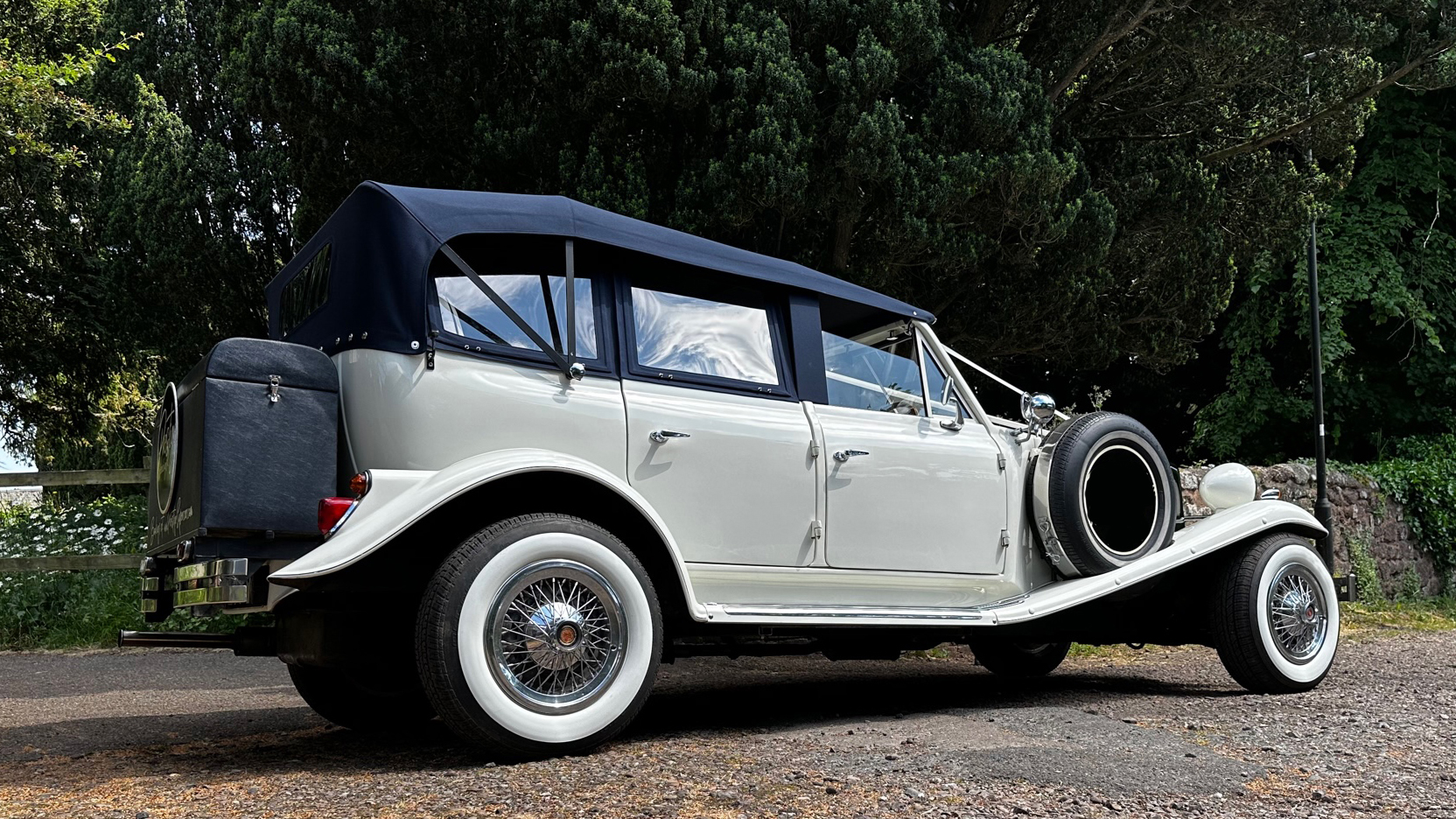 Right side view taken from the rear of a white Beauford showing the 4-door and rear picnic trunk in black