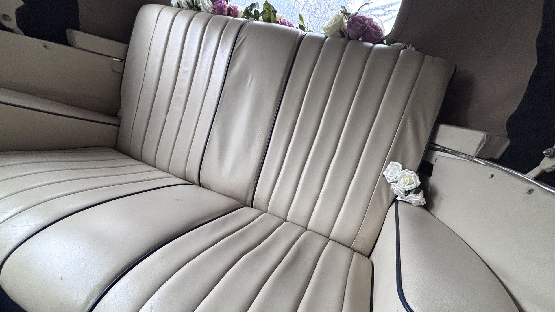 Rear cream leather seat with flower decorated on the parcel shelf