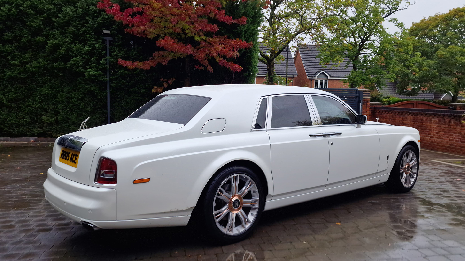 Rear right side view of an all white Rolls-Royce phantom