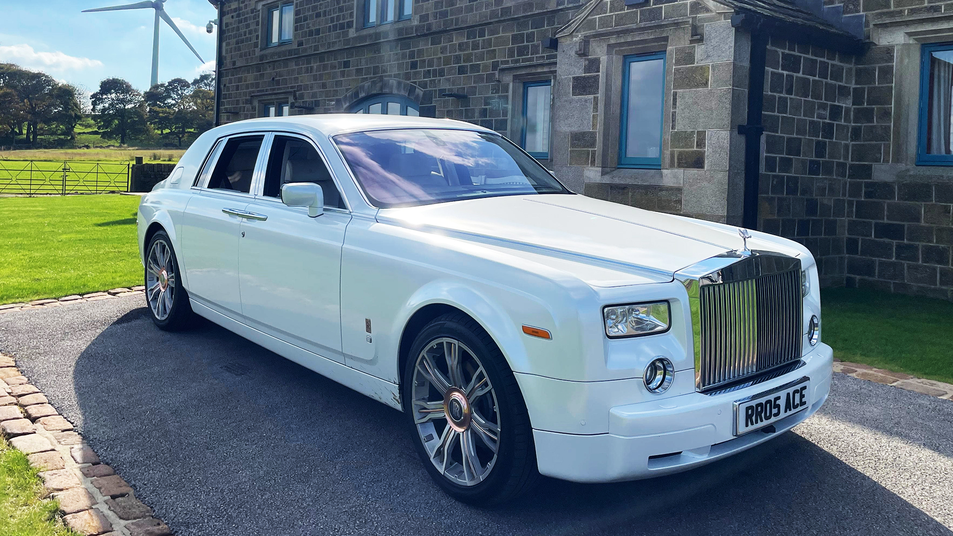 Luxurious white Rolls-Royce Phantom parked outside wedding venue in Liverpool