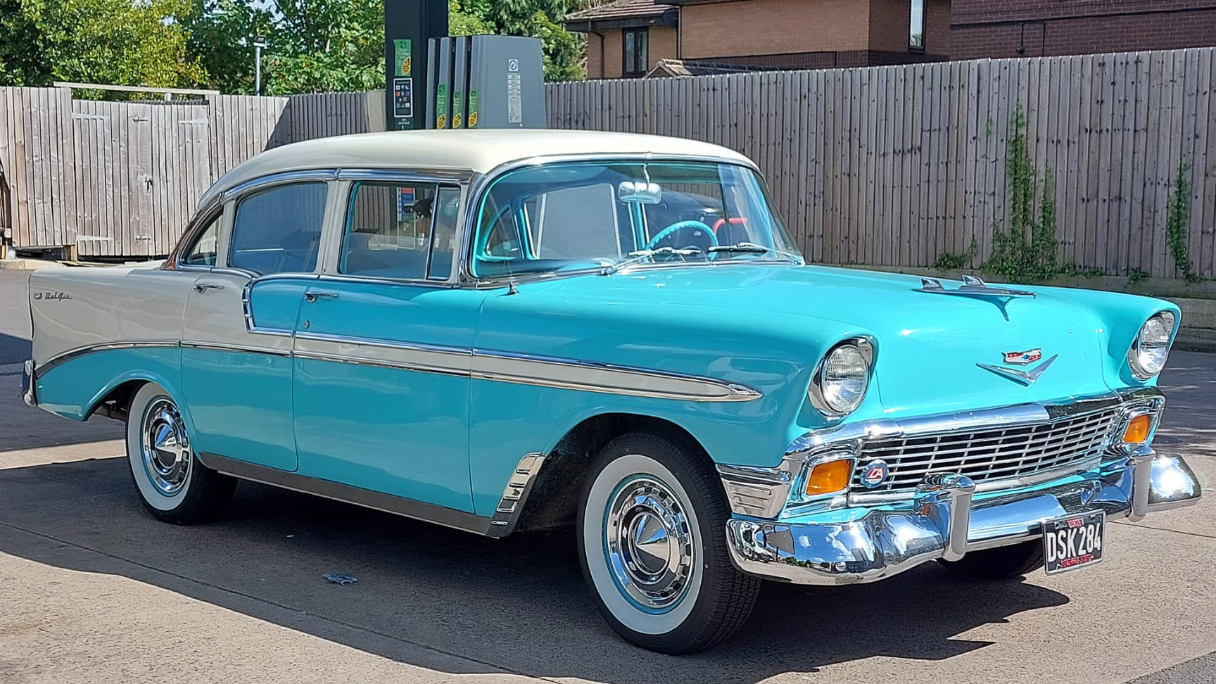 American Chevrolet BelAir in Teal Blue and White with large white wall tires and chrome bumpers