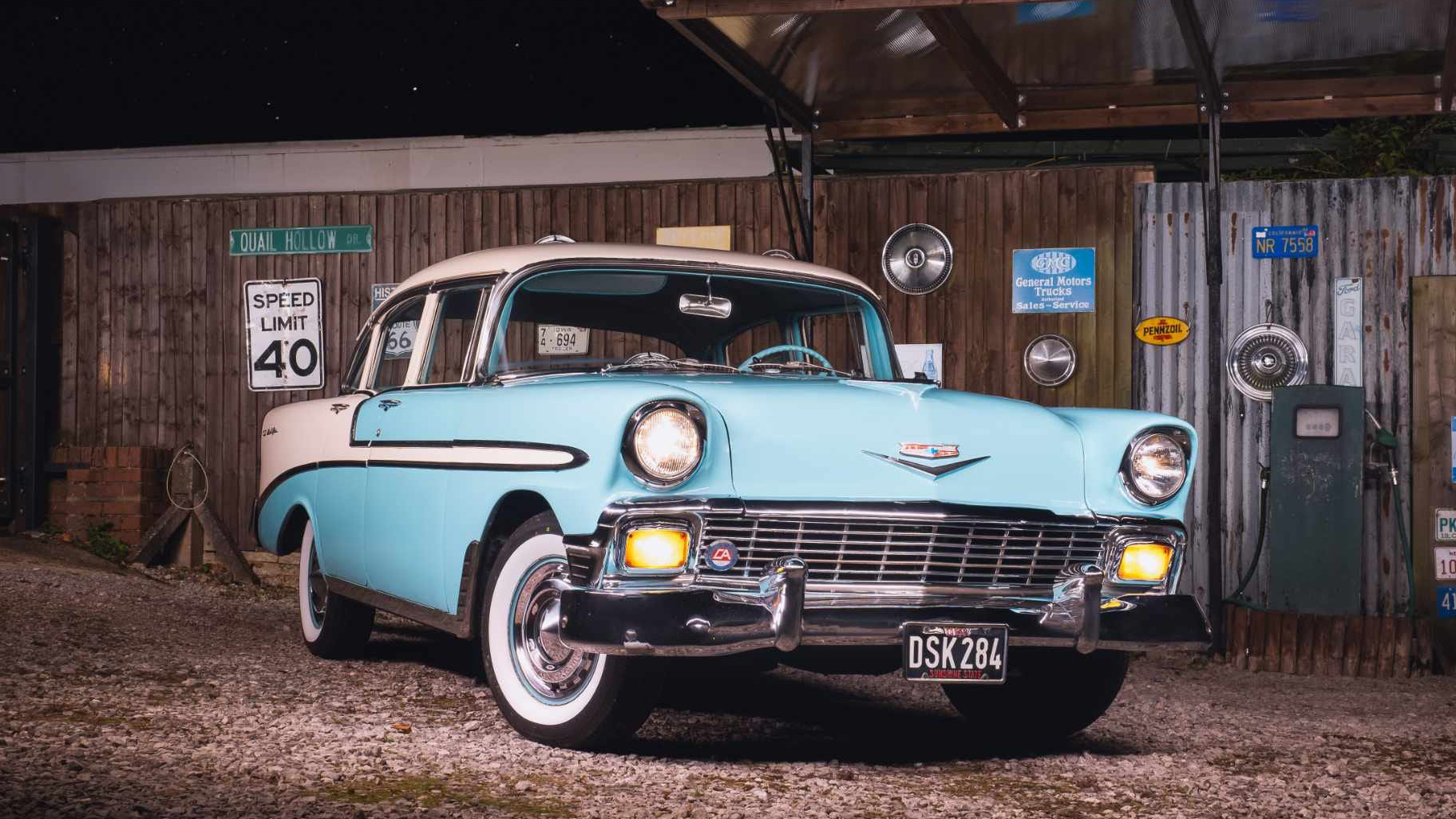 American Chevrolet BelAir at dusk with headlights