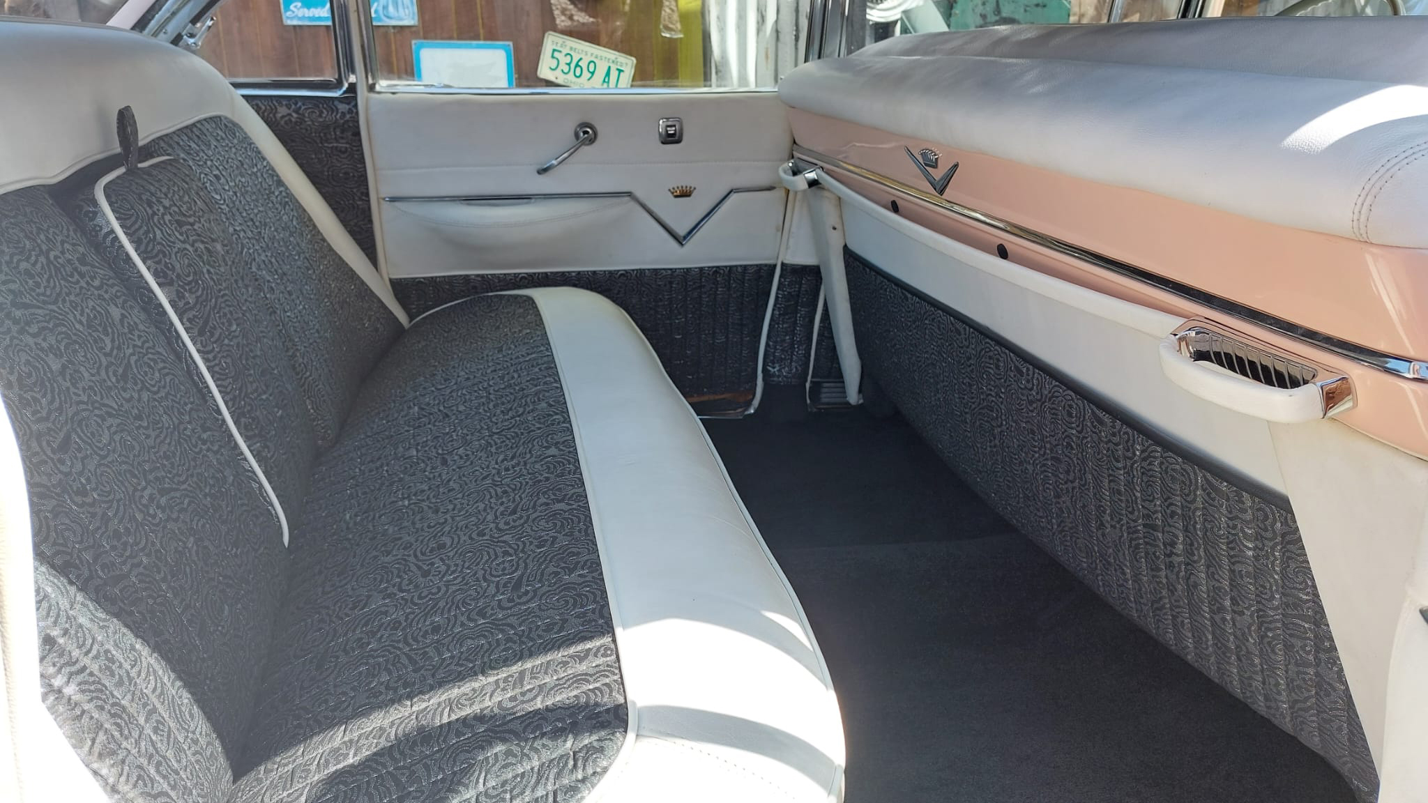 Rear Black and White interior bench seat inside Classic Cadillac