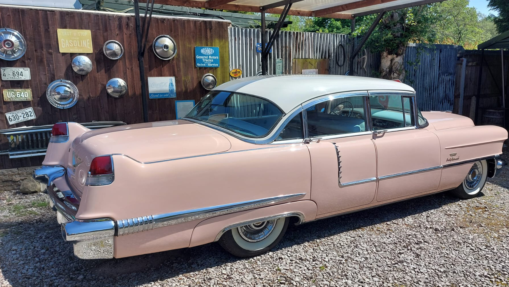 Right side classic American Cadillac with 50s American decoration hanging on a wall in the background