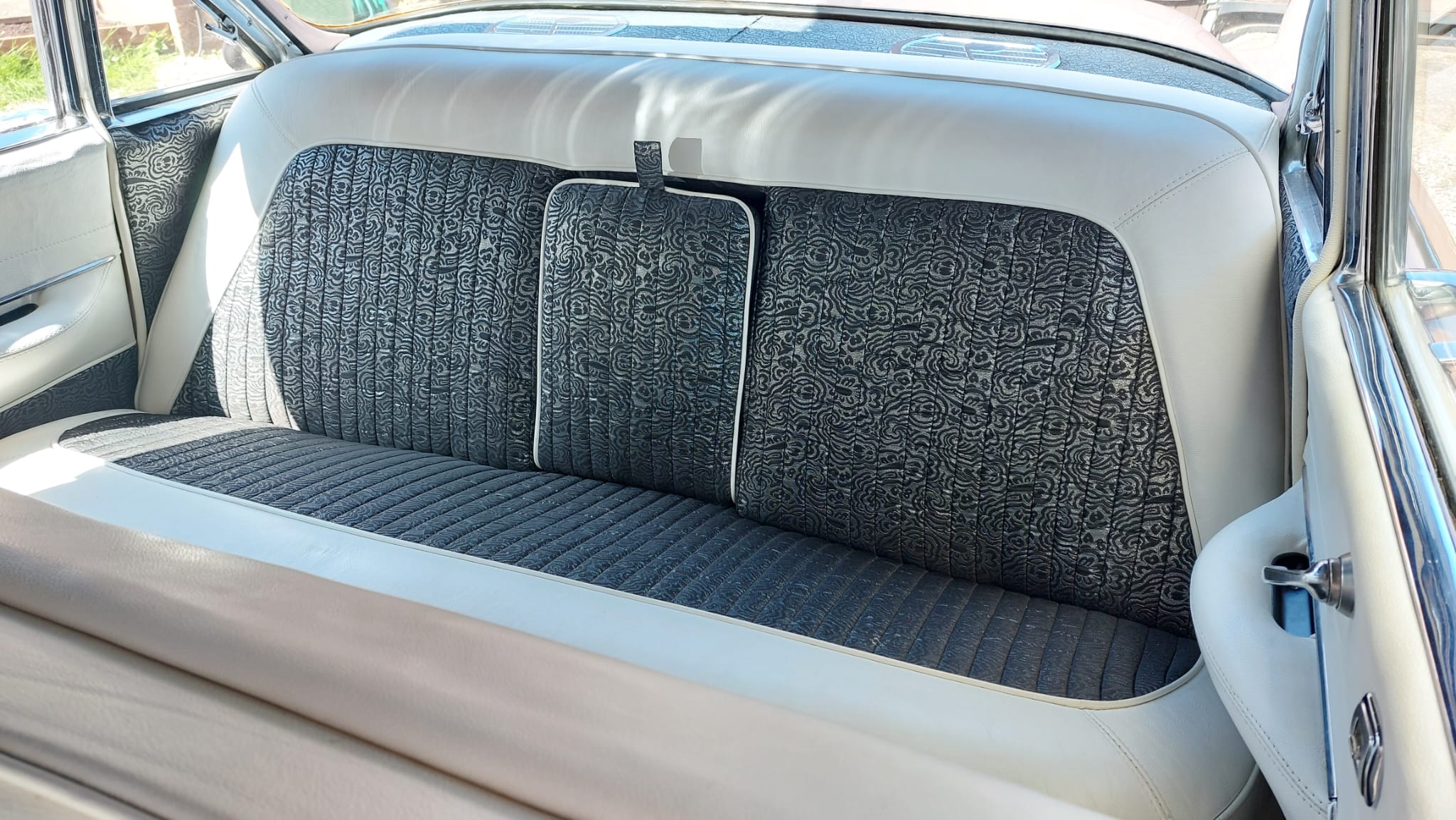 Black and White rear bench seat inside American Cadillac