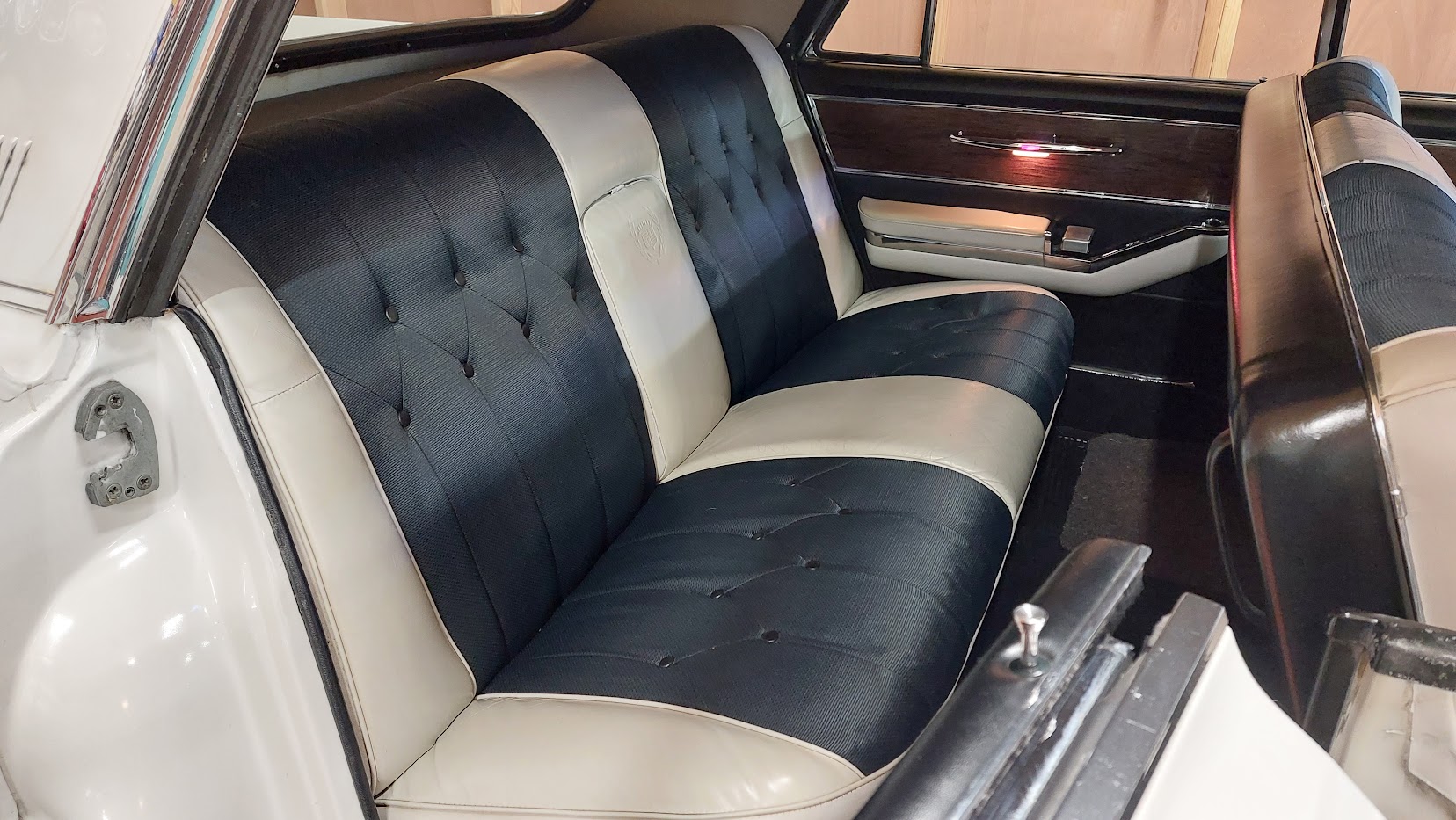 Rear two-tone Black and White bench seat inside Cadillac