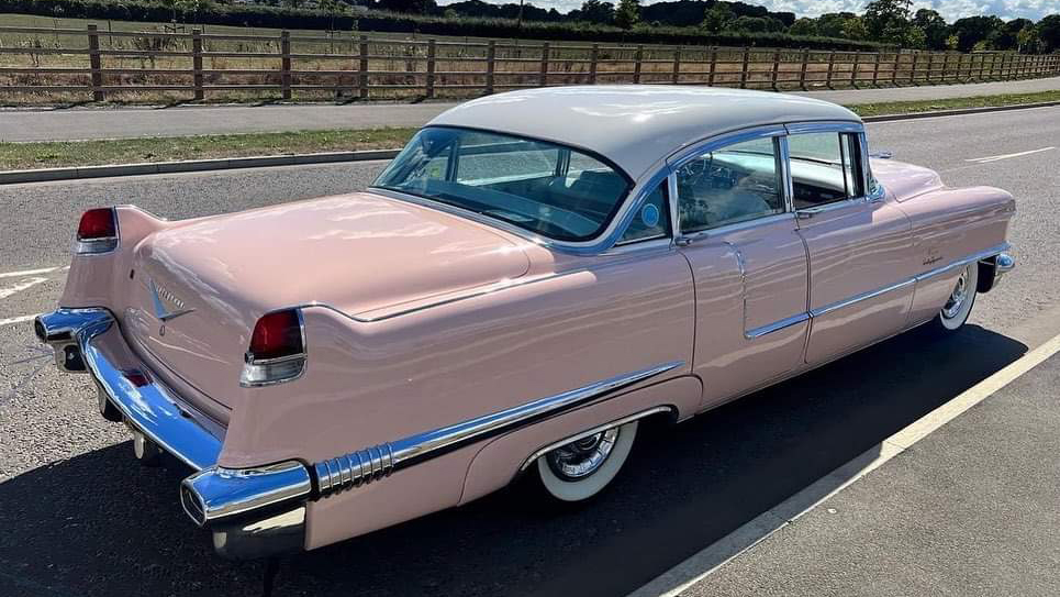 rear right side view of Classic Pink American Cadillac Fleetwood with white roof