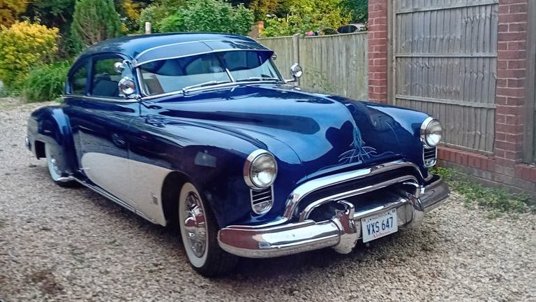 Right side view of Oldsmobile Rocket 88 in Blue with white bottom doors