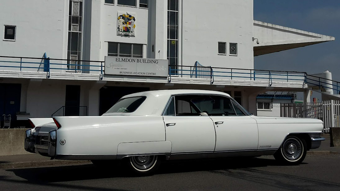 Right side view of a Classic White American Fleetwood in front of wedding venue in Midlands