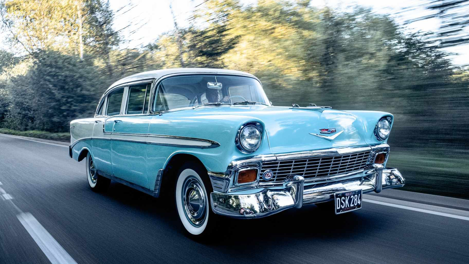 American Chevrolet BelAir in Blue and White driving on the road