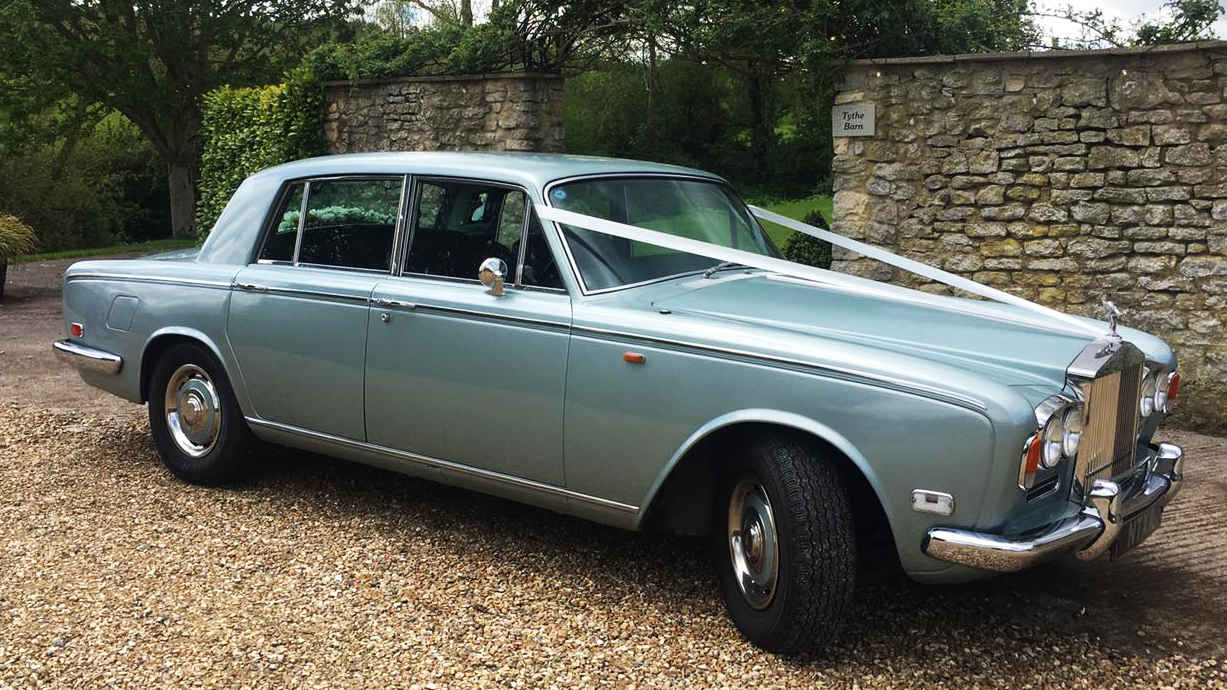 Right side view of a classic Rolls-Royce Silver Shadow in Mint Silver dressed with Ivory ribbons