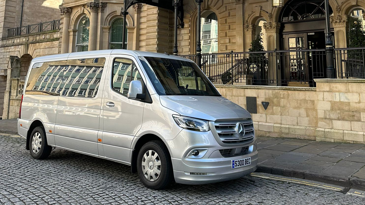 Silver Mercedes Sprinter mini bus parked in front of the Marriott Hotel in Bristol