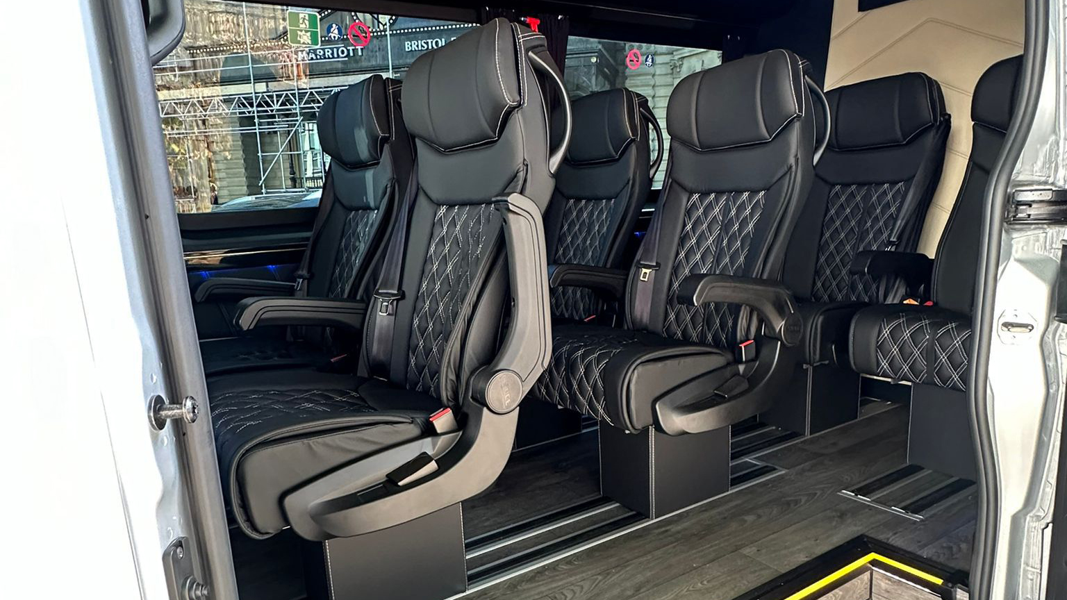 Black Leather forward facing seats inside the rear compartment of Mercedes Minibus