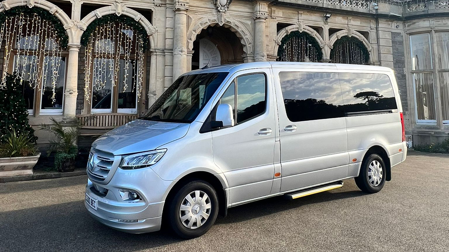 Left side view of Mercedes Sprinter Mini Bus with large privacy rear windows