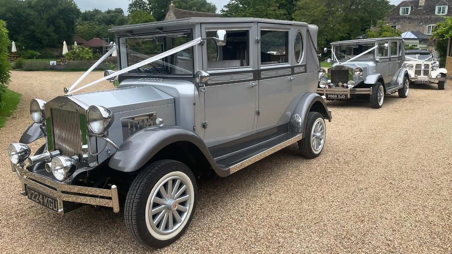 Silver Imperial dressed with white ribbons followed by a second identical vintage Imperial