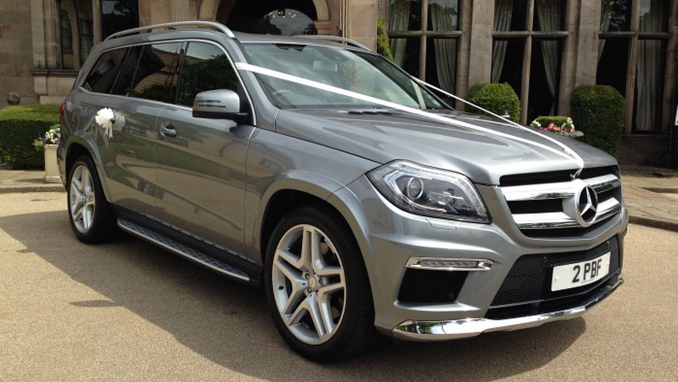 Silver Mercedes GLS 4x4 dressed with white ribbons