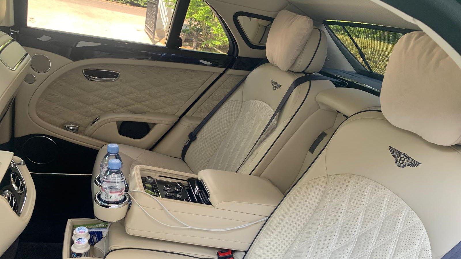 Rear interior cream leather seats with embroidered Bentley logo on the rear seats