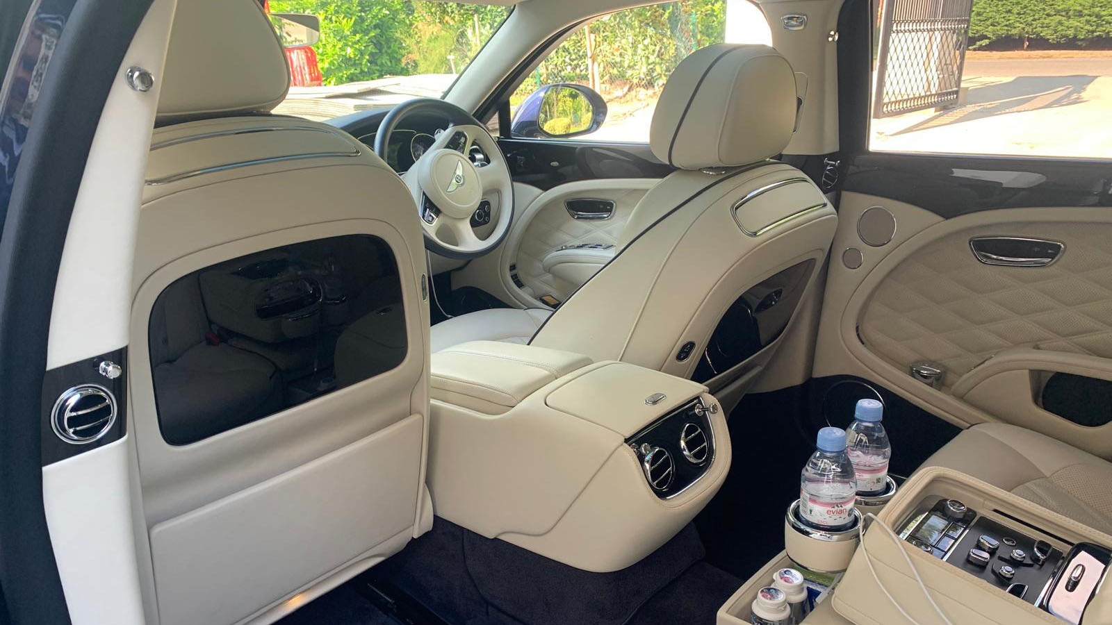 Bentley Mulsanne rear interior photo with cream leather interior, blue carpet and wooden picnic table