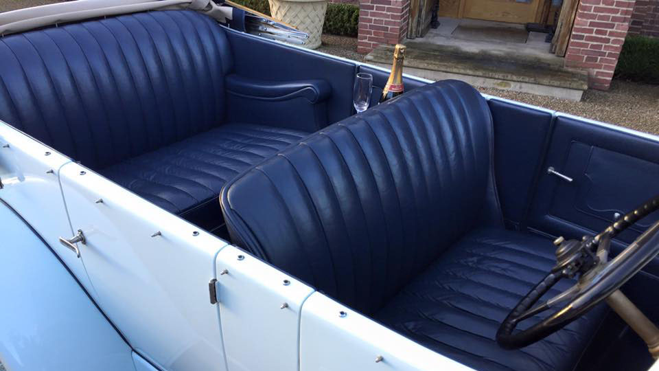 blue leather seats inside vintage Rolls-Royce.