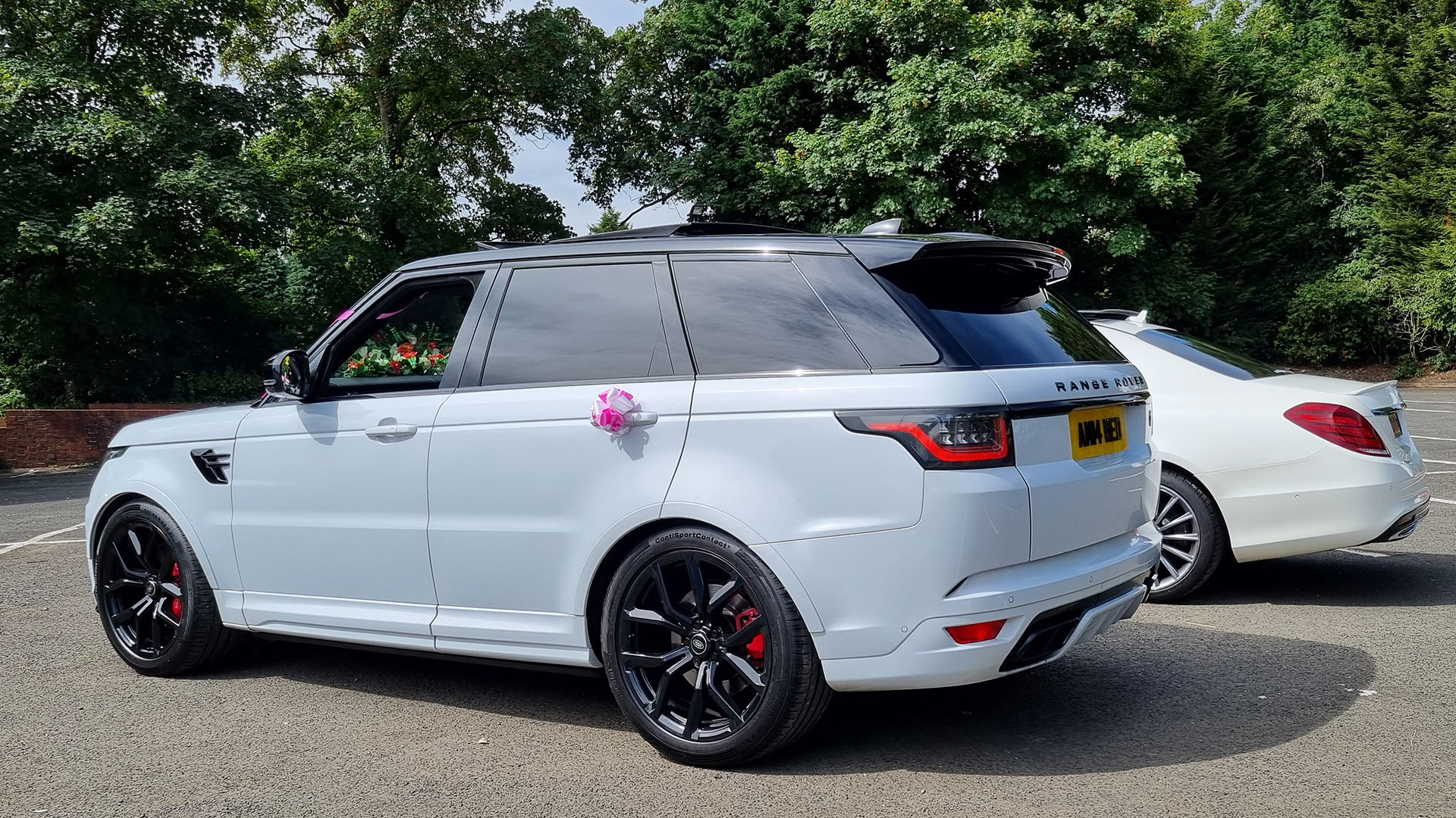 Rear view of white range rover with rear passengers privacy windows