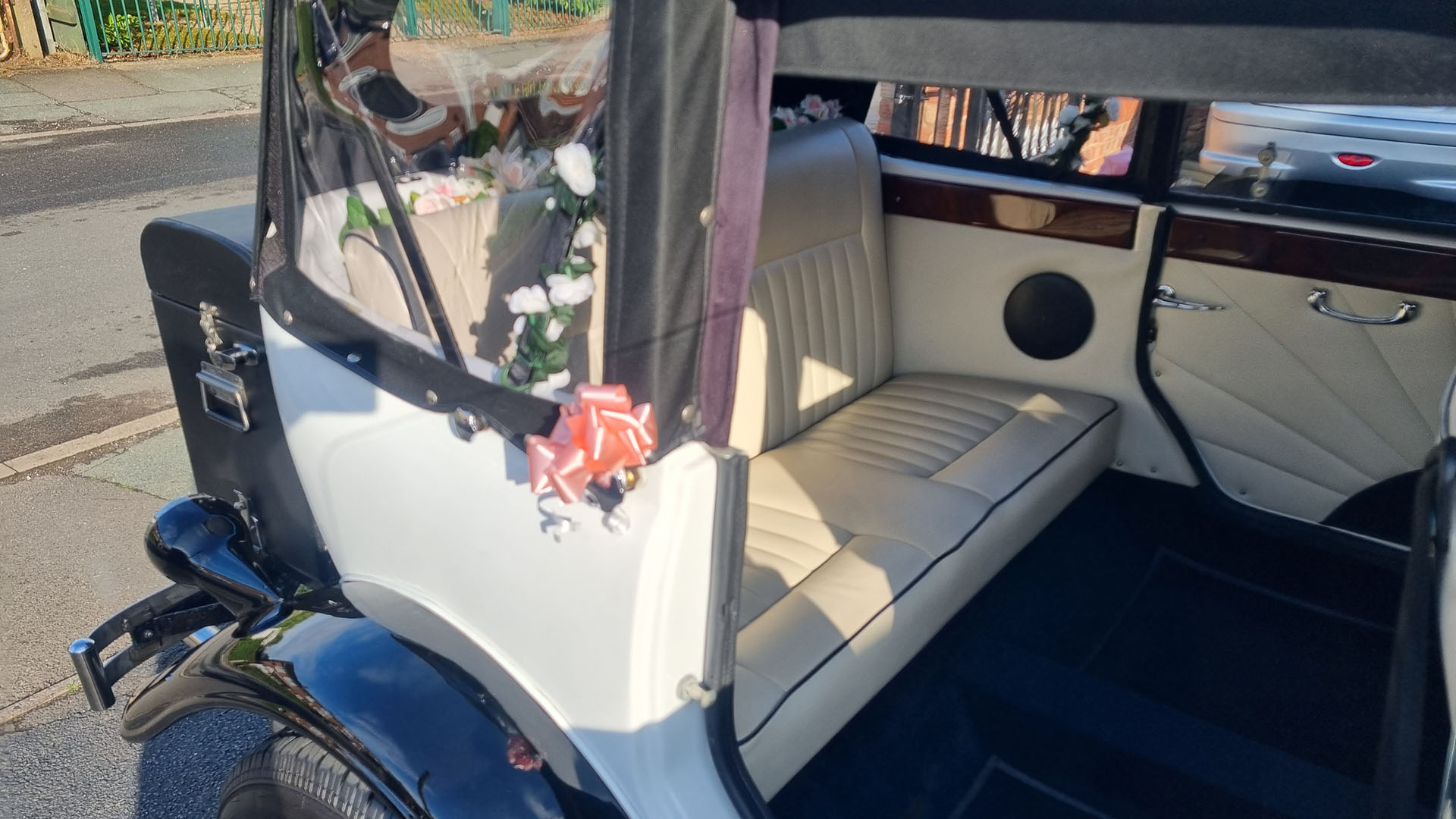 Rear driver side door open showing cream leather interior seats inside Beauford