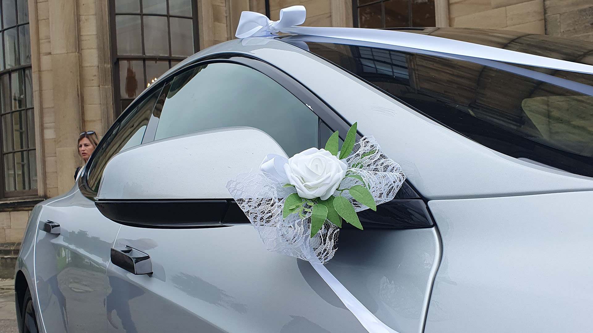 Bow attached to wing mirror on a Tesla S