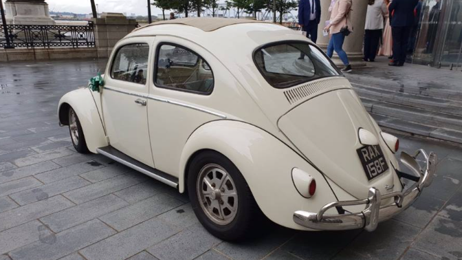 Rear view of Ivory Classic Volkswagen Beetle with view of the Webasto sunroof.