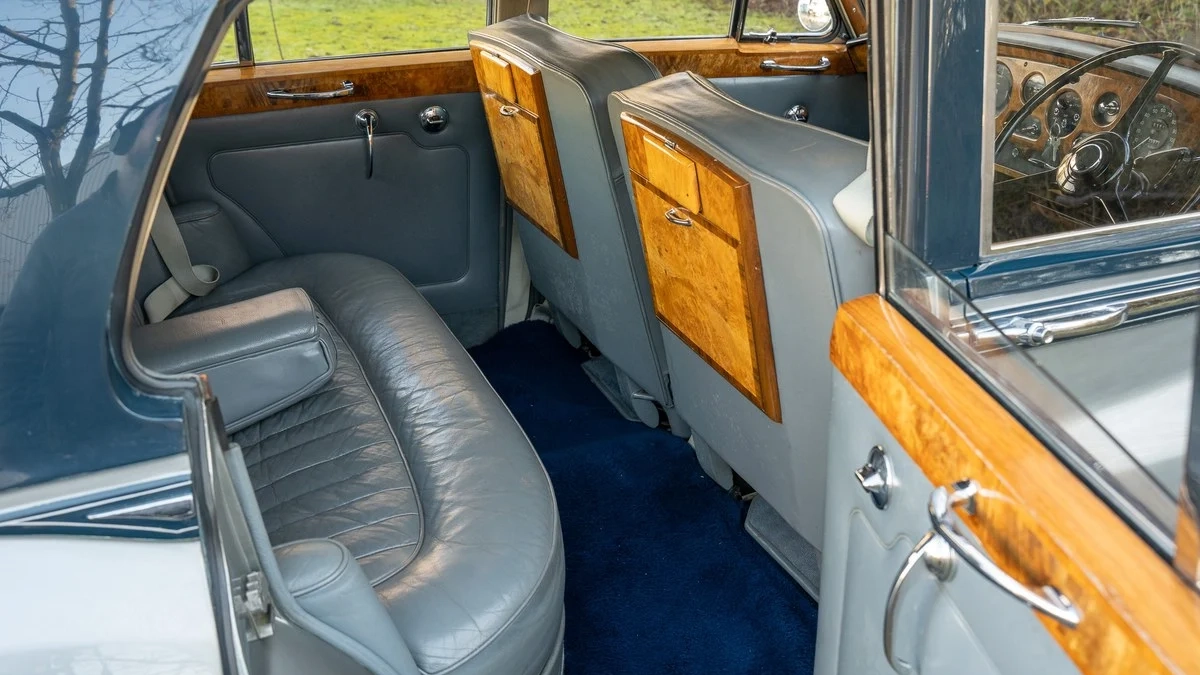 Rear interior silver leather with royal blue carpet, wooden picnic table and top of door cards