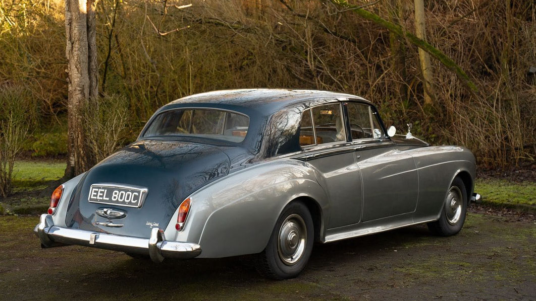 Right side rear view of Classic Rolls-Royce Silver Cloud with Silver on the side and dark blue on top of the roof and boot