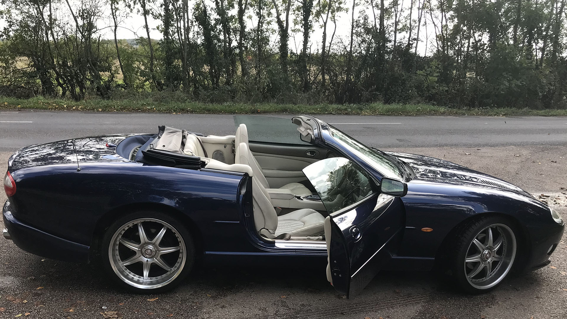 Right side view of Jaguar XKR with roof down and front driver door open