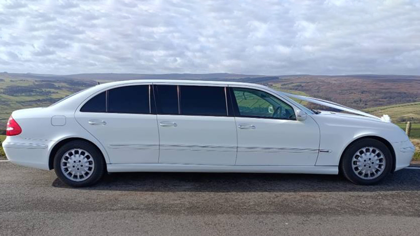 White Stretched Mercedes Limousine with tinted rear windows