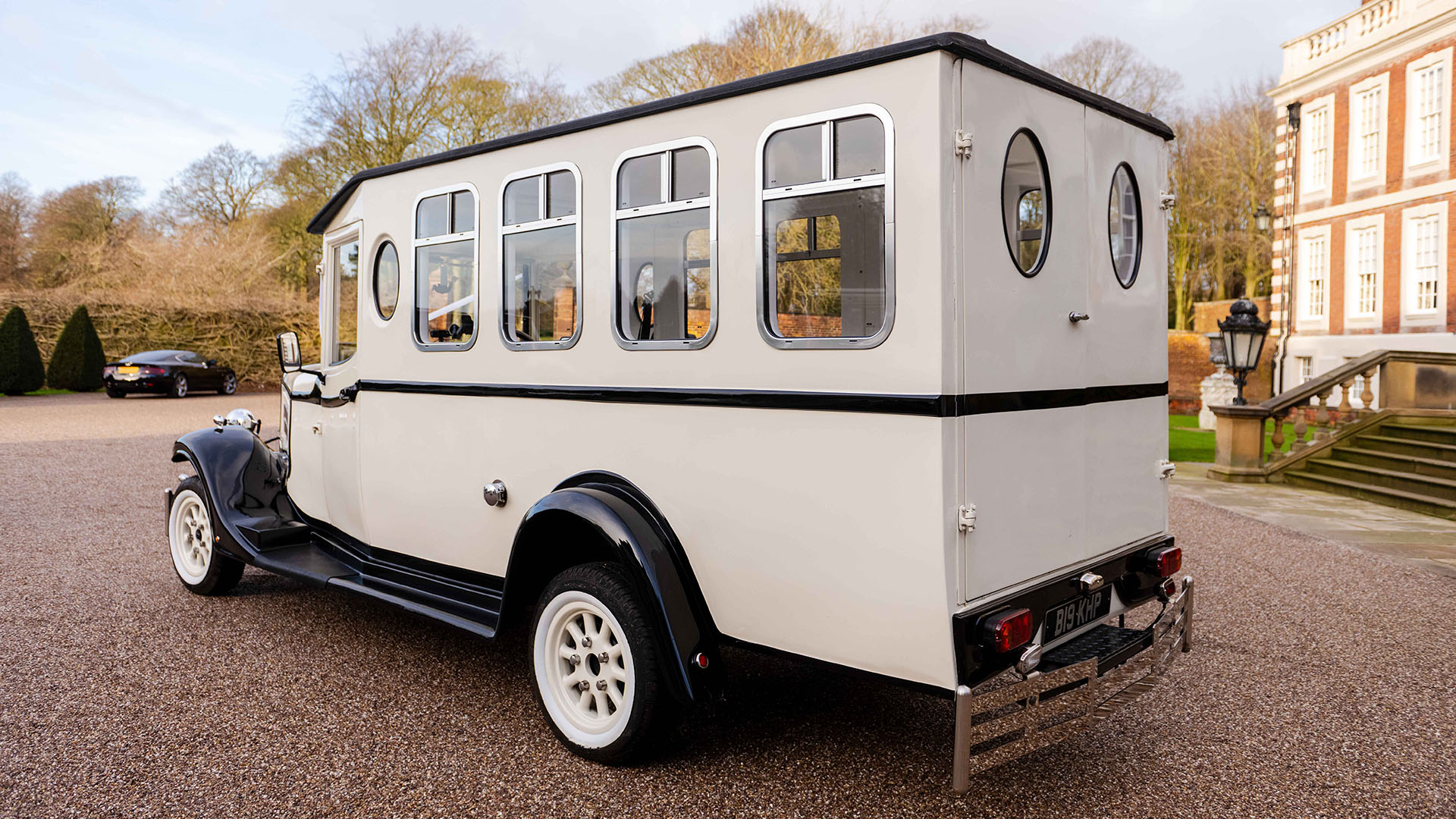 Rear view of an Asquith Bus in Old English White with white wheels and large rear rectangular windows