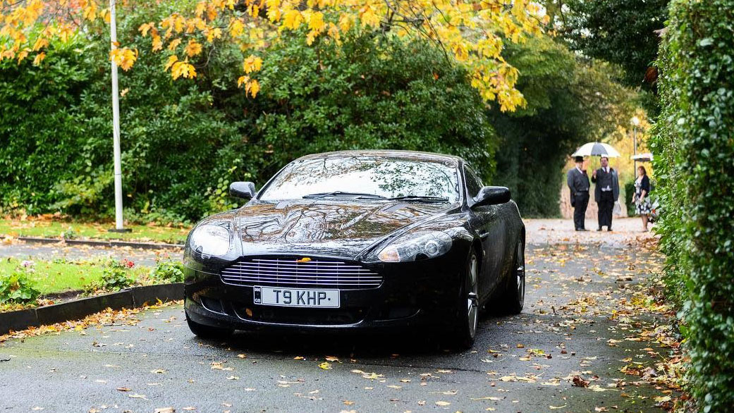 Black Aston Martin DB9 entering wedding venue in Liverpool