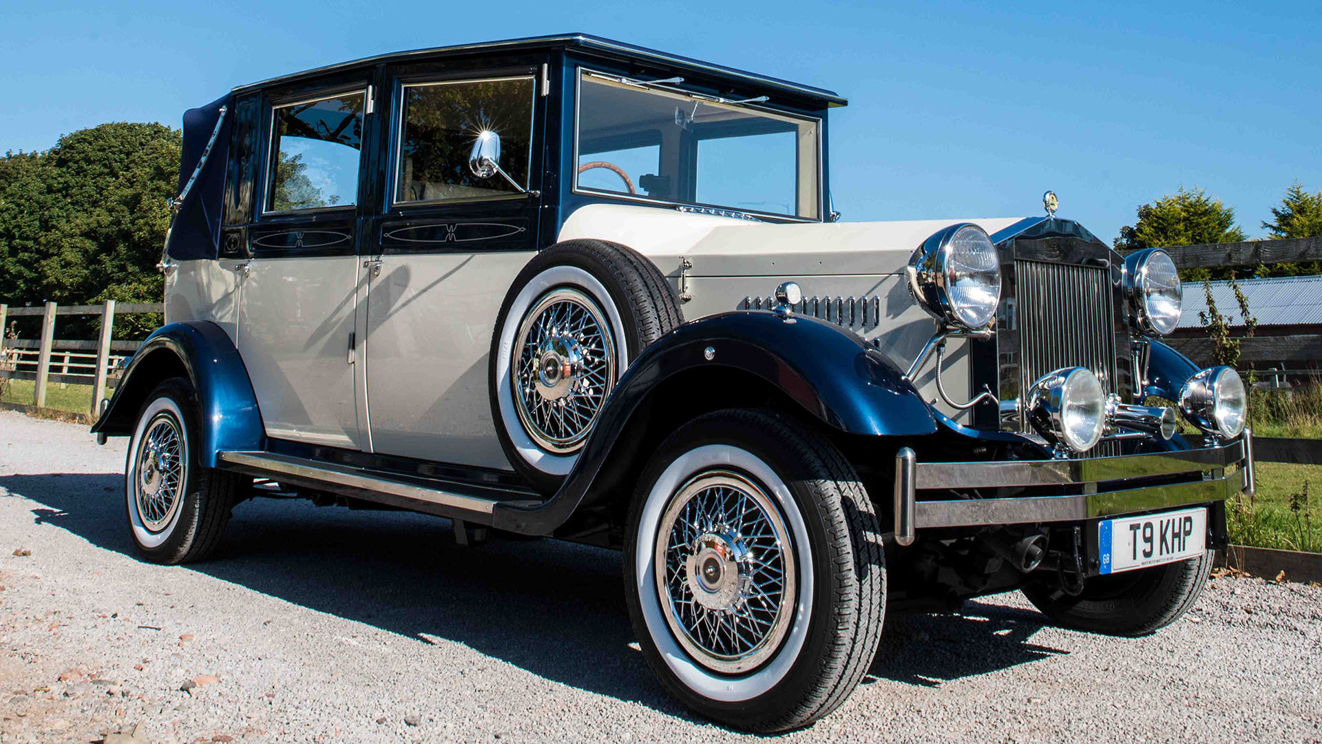 Vintage Imperail in two-tone Ivory and Metallic Blue with spare wheel mounted on the side of the vehicle